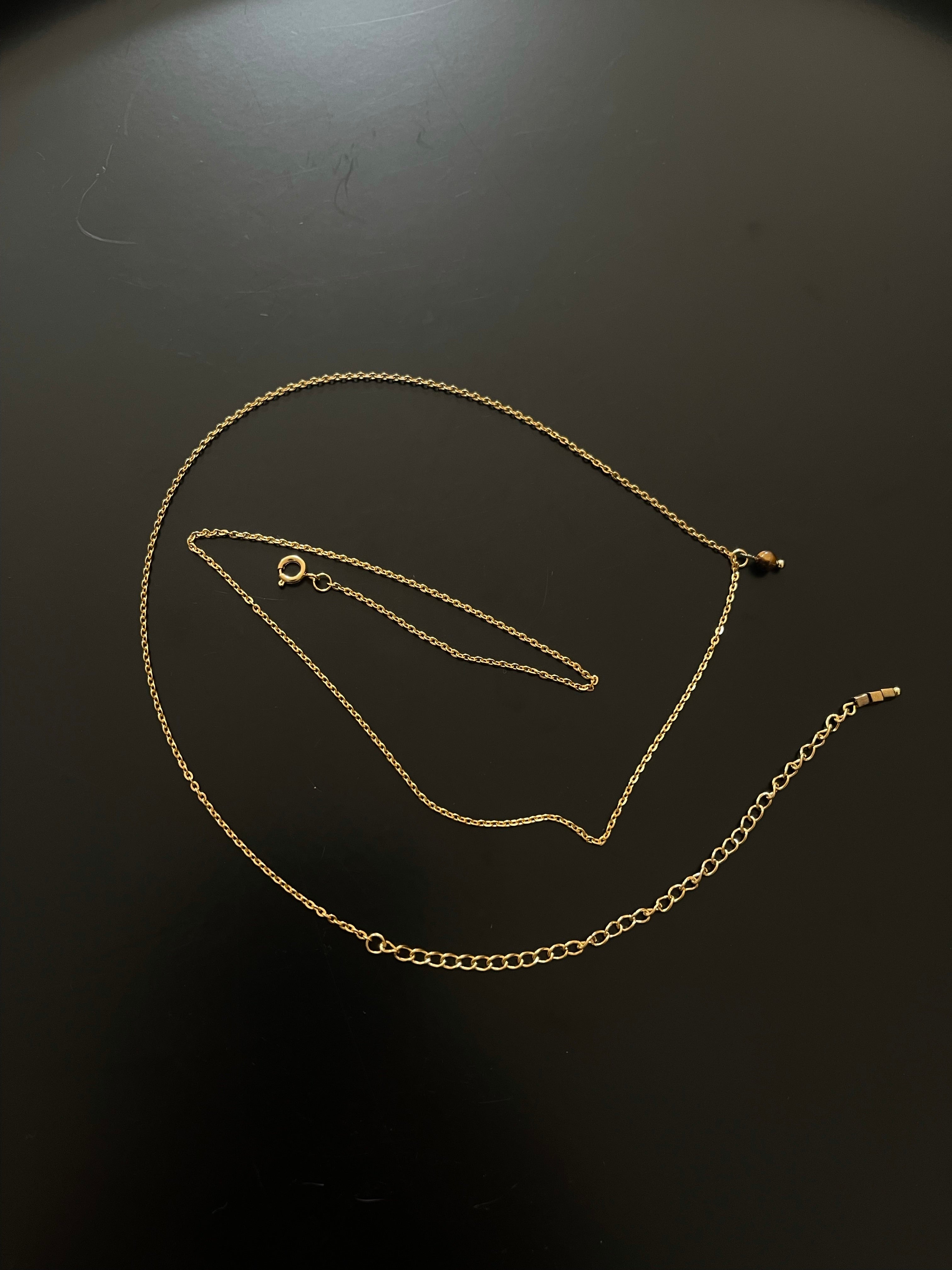 Golden body chain with one round tiger eye pendant and 3 square tiger eye beads at the end.